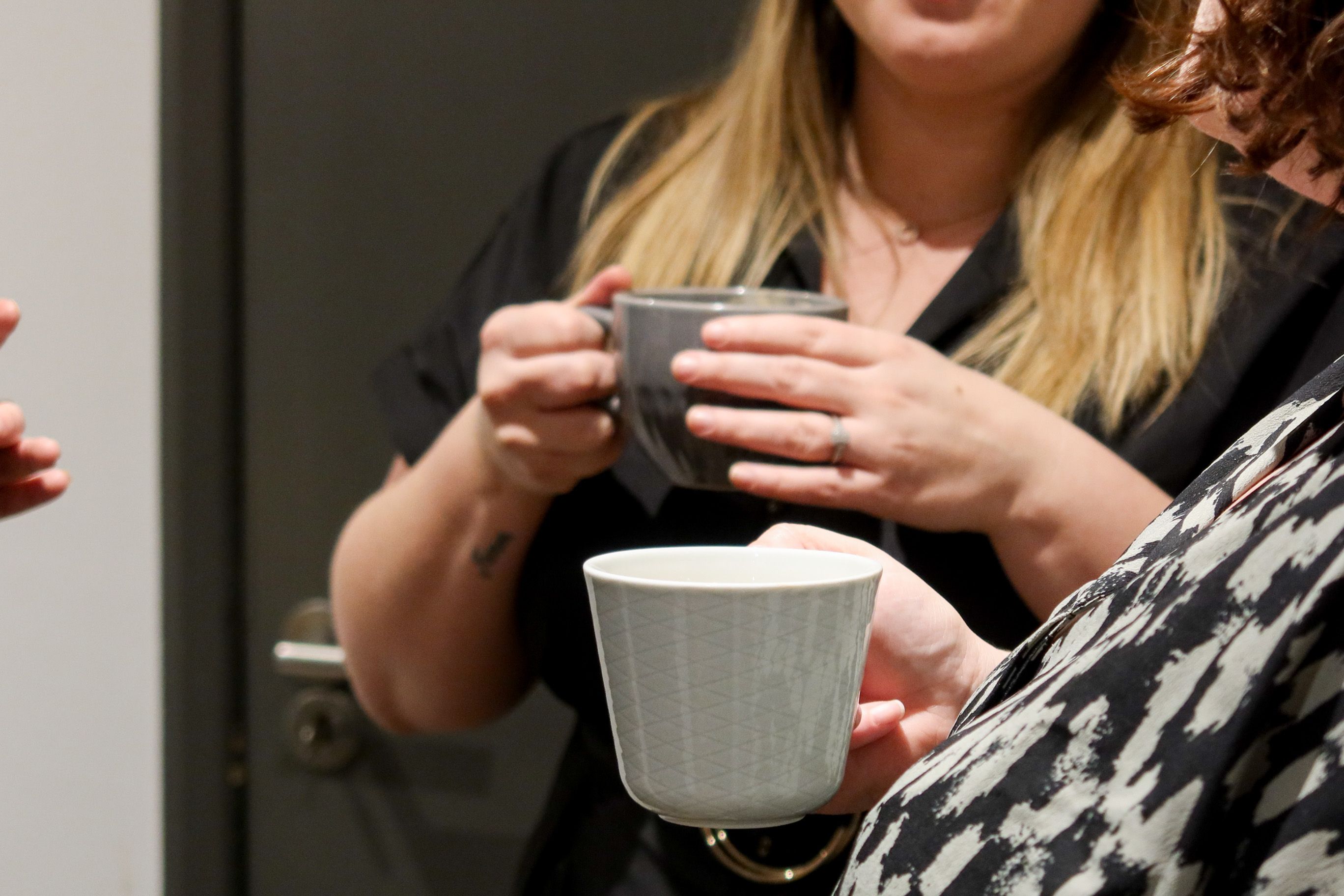 Colleagues at Signet Recruitment and Retention share a moment over a tea break, indicative of the company’s warm, communal culture.