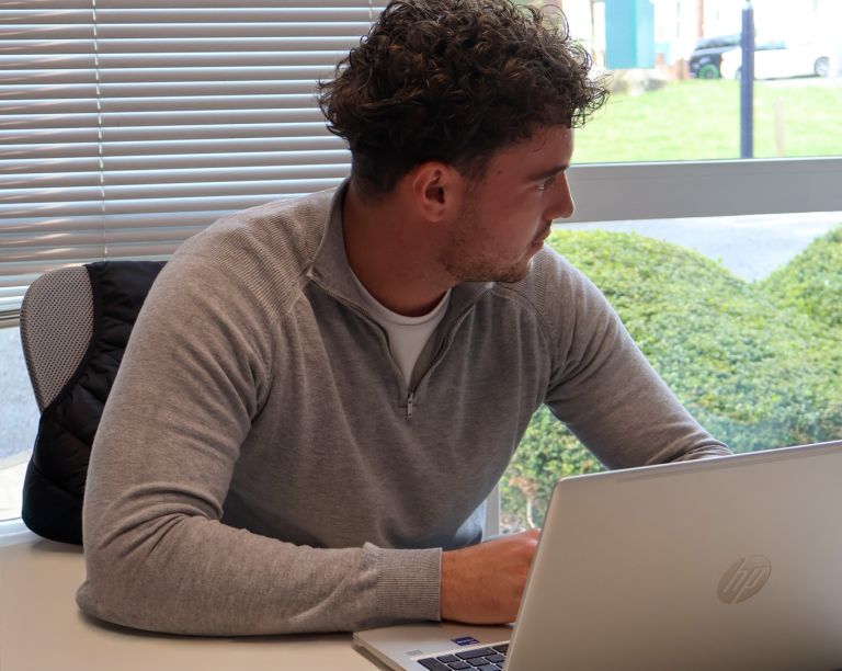 Signet Resources recruitment team engaged in a discussion around a table, with a whiteboard outlining key points in the background.