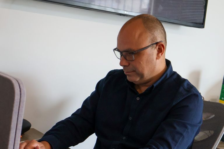 A dedicated Signet Resources staff member focused on recruitment planning, jotting down notes beside her laptop.