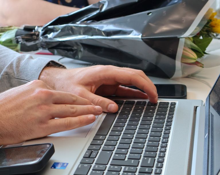 Signet Resources recruitment team engaged in a discussion around a table, with a whiteboard outlining key points in the background.