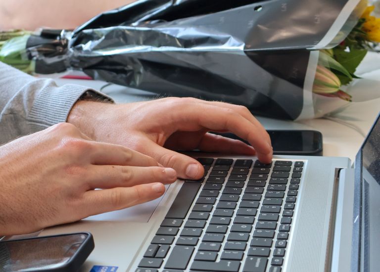 A Signet Resources team member discussing recruitment strategies, with an inspiring team vision board in the background.