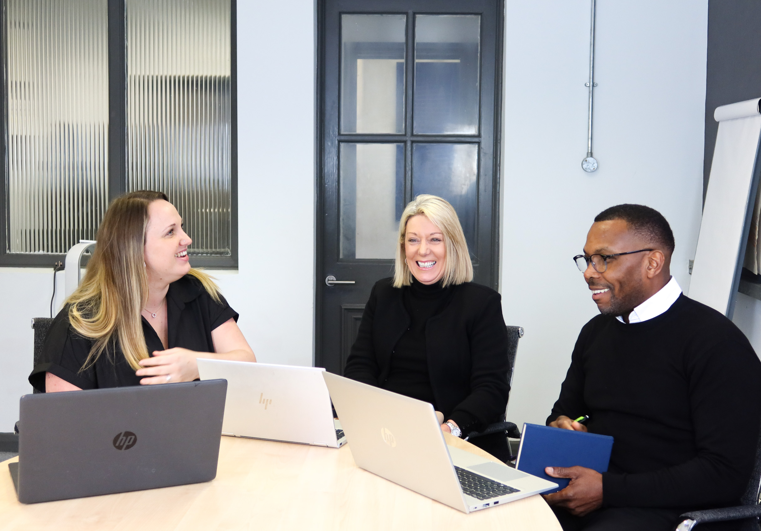 Signet Recruitment and Retention professionals in a deep discussion, likely strategizing over recruitment initiatives.