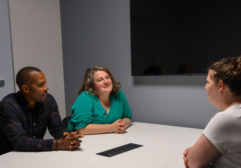 Signet Resources team members engaged in a productive recruitment discussion in an office setting.