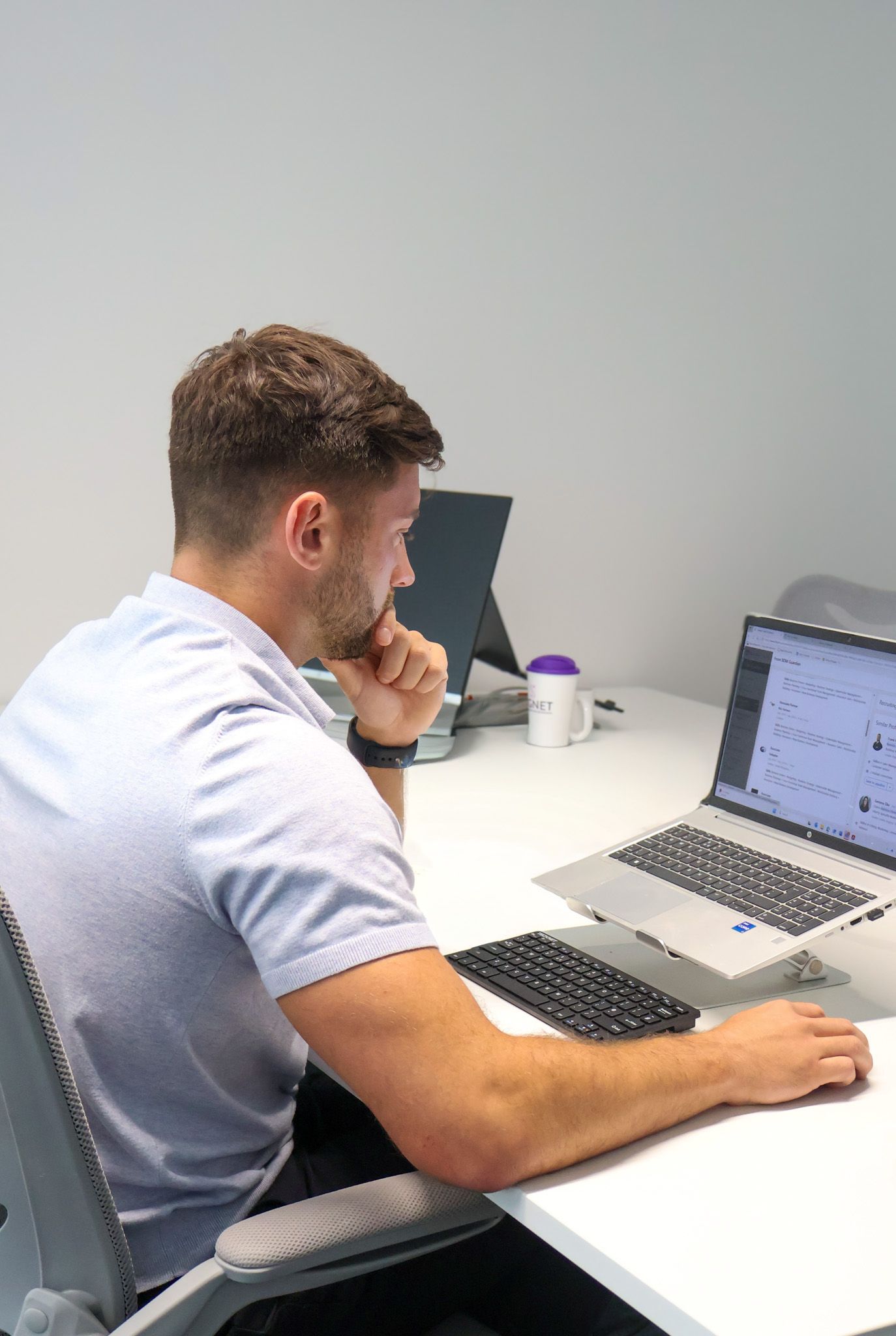 A focused Signet Resources professional attentively participating in a recruitment discussion.