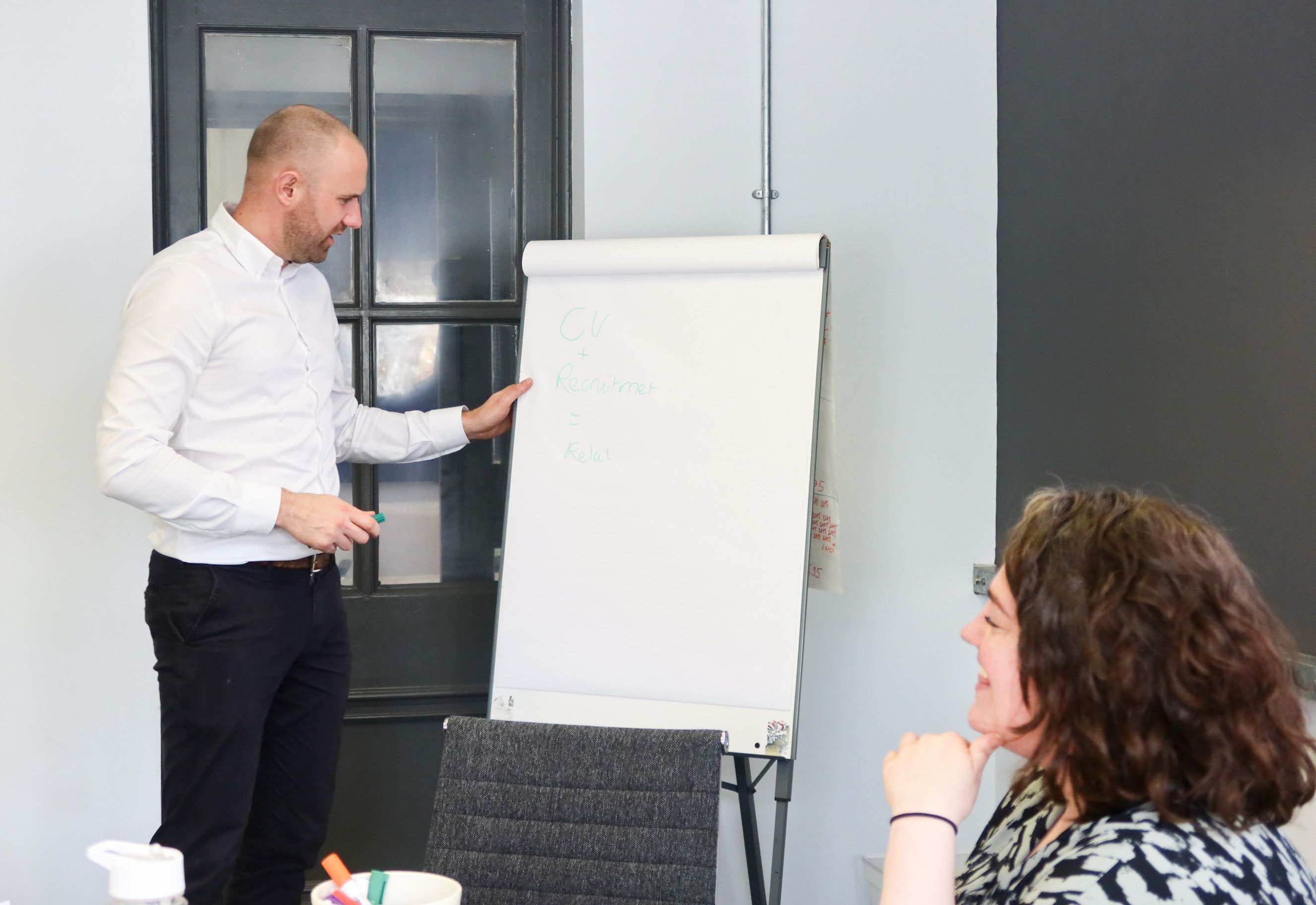 Signet Resources recruitment session with a consultant presenting CV enhancement tips to a colleague.