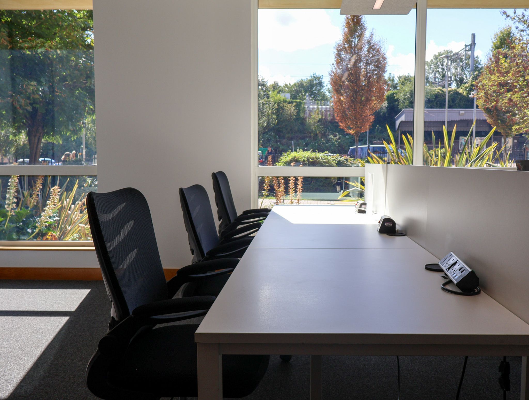 A Signet Resources team member shares insights from a notebook with a smiling colleague, enhancing their recruitment approach.