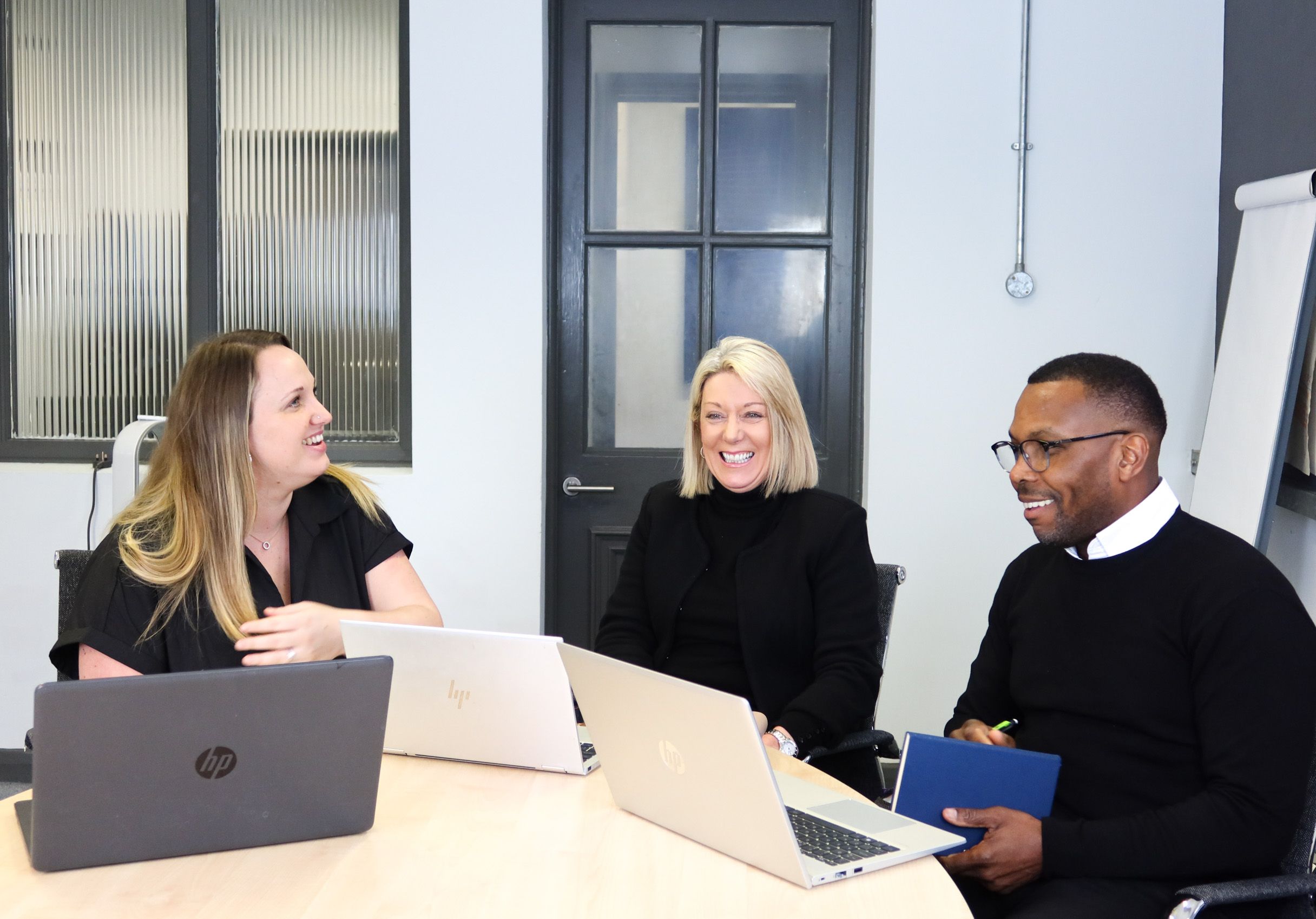 Signet Resources team members engaged in a productive recruitment discussion in an office setting.