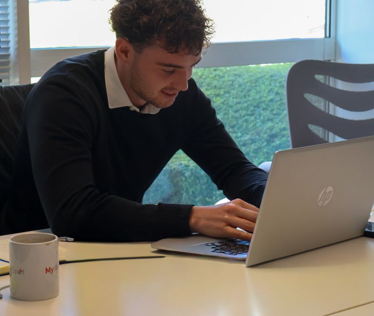 Signet Resources recruitment team engaged in a discussion around a table, with a whiteboard outlining key points in the background.