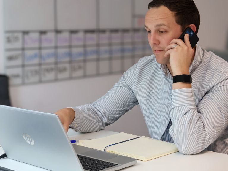 Three colleagues from Signet Resources enjoying a light-hearted moment during a recruitment strategy meeting.